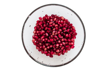 Berries of a pomegranate in water on a white background