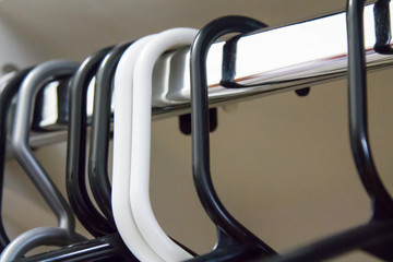 Plastic hangers on a metal closet rod