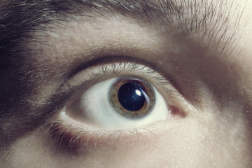 Male eye with dilated pupil - 104593693