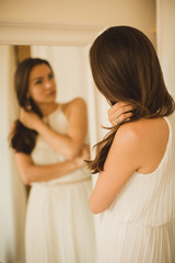 Fototapeta premium girl looks at himself in mirror