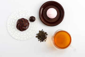 Double sided wall glass cup full of green tea with sweets and biscuits