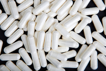 white pills on black