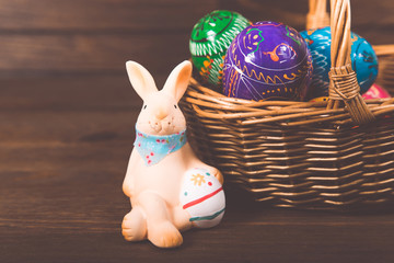 Easter rabbit  with basket of colored eggs