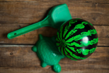 green children's toys on wooden background