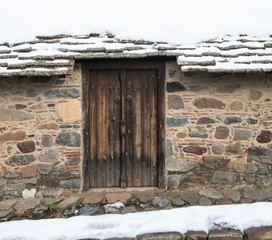 Wooden closed door and Snow.