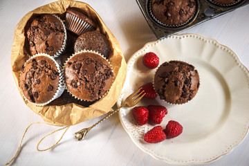 Chocolate muffins with red juicy raspberries