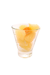 Pomelo and tangerine slices citrus in glass with water drops isolated toned