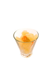 Pomelo and tangerine slices citrus in glass with water drops isolated toned