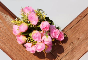 Lovely bouquet on the wooden texture. Roses for the bride. Beautiful flowers. Love story. Nice gift.