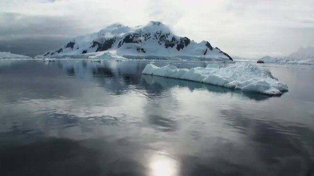 Reflection of clouds and sun on ocean surface in the Antarctica. Amazing beautiful views of Nature and landscape of snow, ice and white of Antarctic. Global Warming.