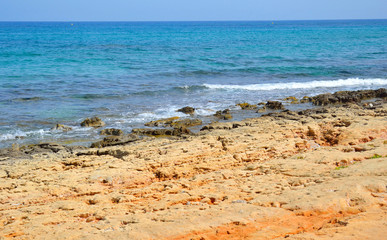 Rocks on the coast of Aegean Sea in Malia, Crete, Greece.