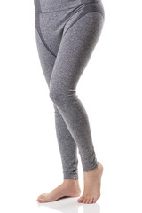 Close up view of woman legs from front side in gray sports thermal underwear with pattern.