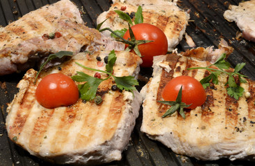 Assorted delicious grilled meat with vegetable over the coals on a barbecue in closeup