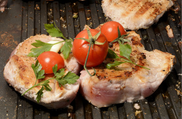 Assorted delicious grilled meat with vegetable over the coals on a barbecue in closeup