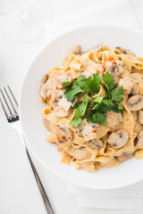 Pasta with creamy sauce, mushrooms and paprika top view