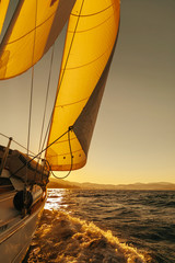 Sailboat crop during the regatta at sunset ocean - 104601676