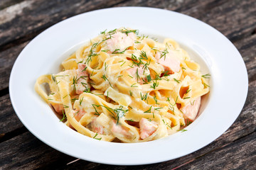 tasty pasta with salmon, dill on plate