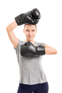 Beautiful young girl with black boxing gloves