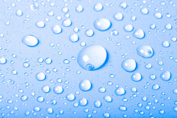Drops of water on a color background. Blue. Shallow depth of fie