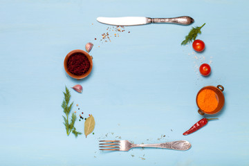 Herbs and spices on light blue wooden background