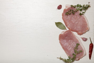Fresh meat steaks on white wooden background