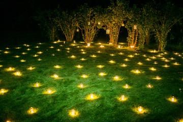 Romantic candle decoration on the summer grass