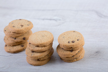Chocolate cookies on wooden table. Cookies with chocolate and nuts