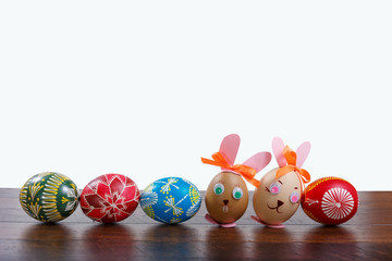 Fototapeta na wymiar hand painted Easter eggs on the wooden texture