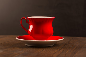 Steaming coffee cup on black wood background