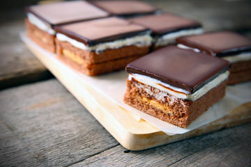 Delicious chocolate brownies on wooden background