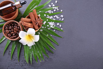 Beautiful spa setting on palm leaf on grey background