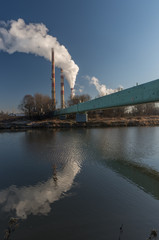 Power plant and overhead pipeline at cold morning over Vistula river, Krakow, Poland