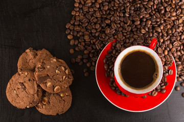 Good morning or Have a nice day message concept - bright red cup of frothy coffee with chocolate cookies, coffee beans