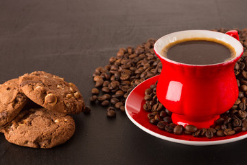 Good morning or Have a nice day message concept - bright red cup of frothy coffee with chocolate cookies, coffee beans