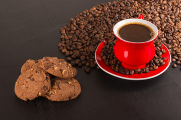 Good morning or Have a nice day message concept - bright red cup of frothy coffee with chocolate cookies, coffee beans