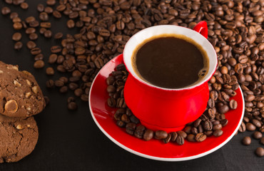 Good morning or Have a nice day message concept - bright red cup of frothy coffee with chocolate cookies, coffee beans