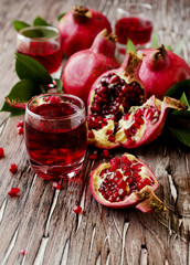 Fresh pomegranates and juice, selective focus