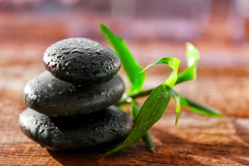 Spa stones with bamboo on wooden background