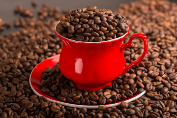 Cup of coffee beans on coffee beans background