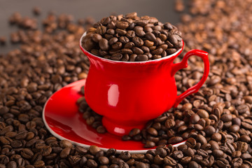 Cup of coffee beans on coffee beans background