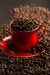 Cup of coffee beans on coffee beans background