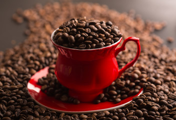 Cup of coffee beans on coffee beans background