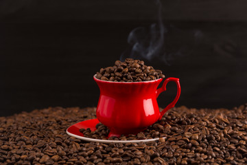 Cup of coffee beans on coffee beans background