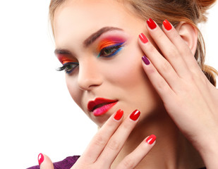 Fototapeta premium Beautiful girl with colorful makeup and manicure, isolated on white