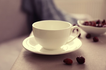 Rose hip tea on the table in the room, closeup