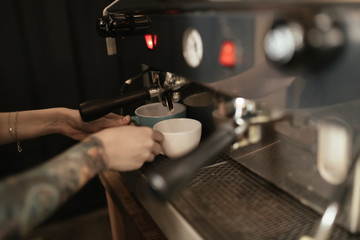 Fototapeta na wymiar Barista preparing coffee in coffee shop