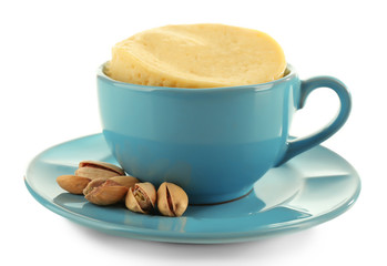 Mug cake with pistachios isolated on white