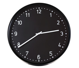 Round black wall clock, isolated on white
