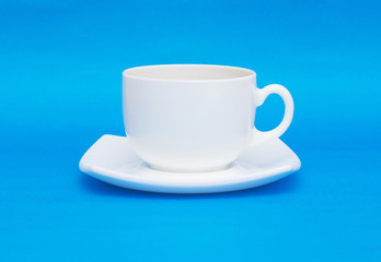 White cup isolated on blue background