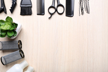 Barber set with tools and cosmetic on light wooden table